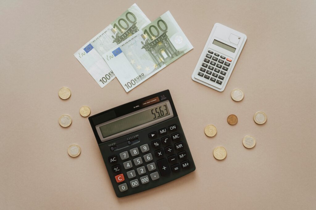 Flat lay of calculators and Euro currency, depicting financial calculations and budget management.